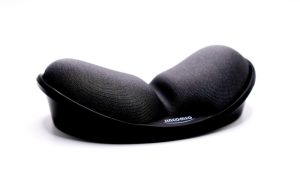 a close up of a black pillow on a white surface